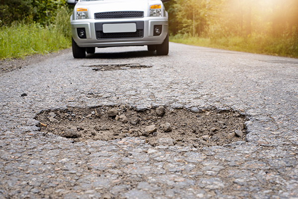 Why Does My Car Pull to One Side After Hitting a Pothole? | The Auto Doc